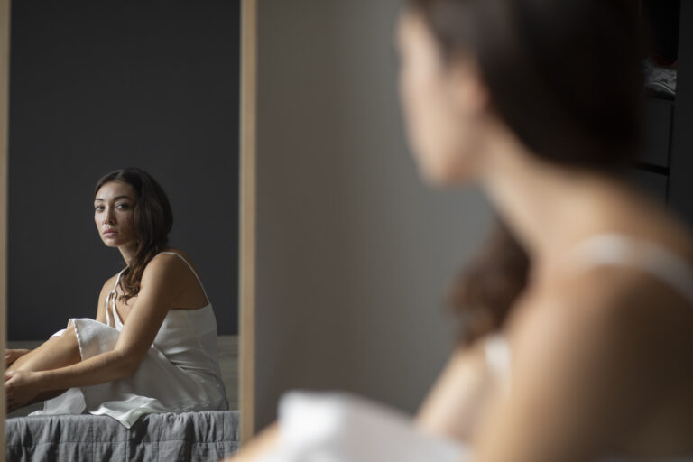 portrait-young-woman-with-low-self-esteem-with-mirror